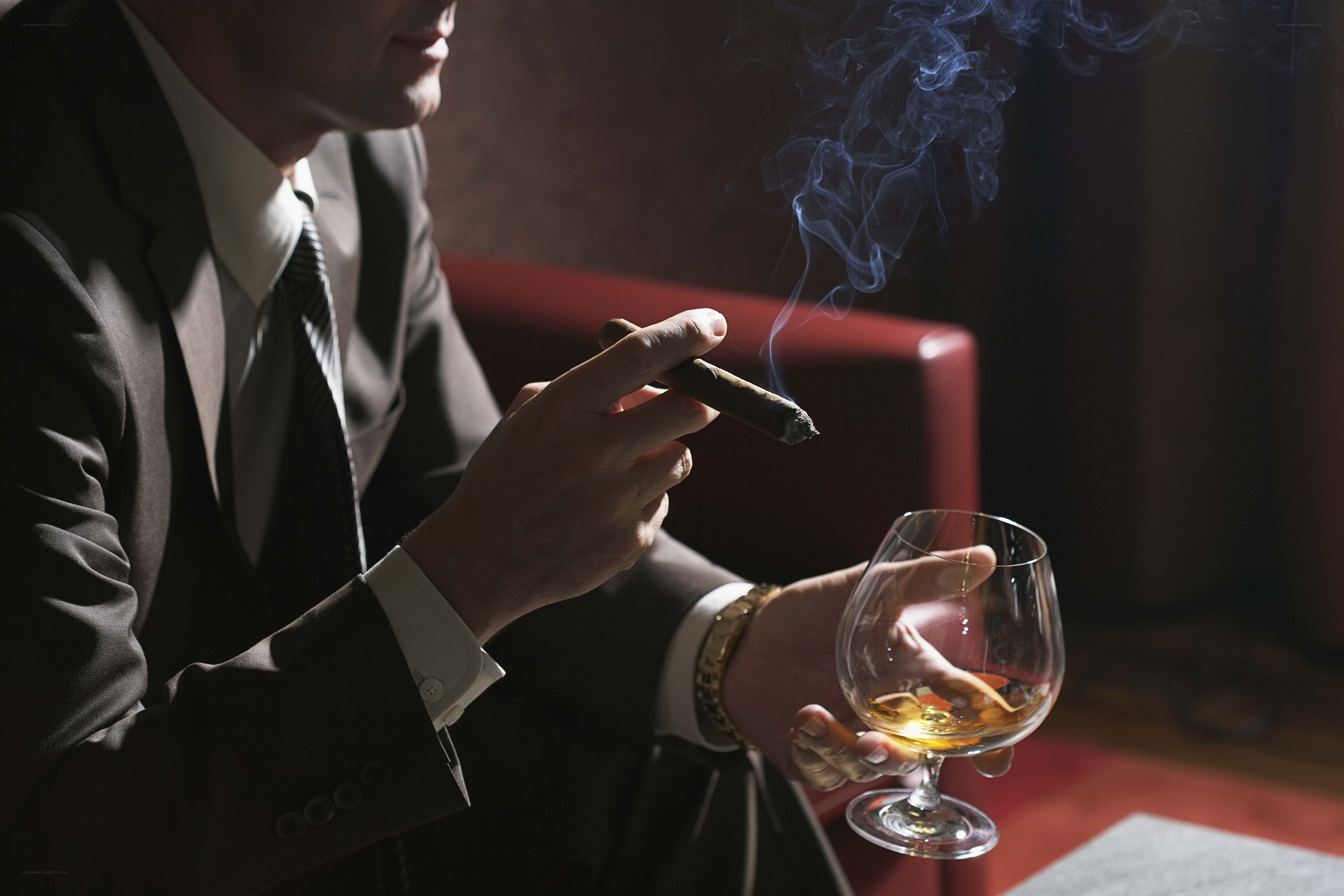 man with cigar and whiskey