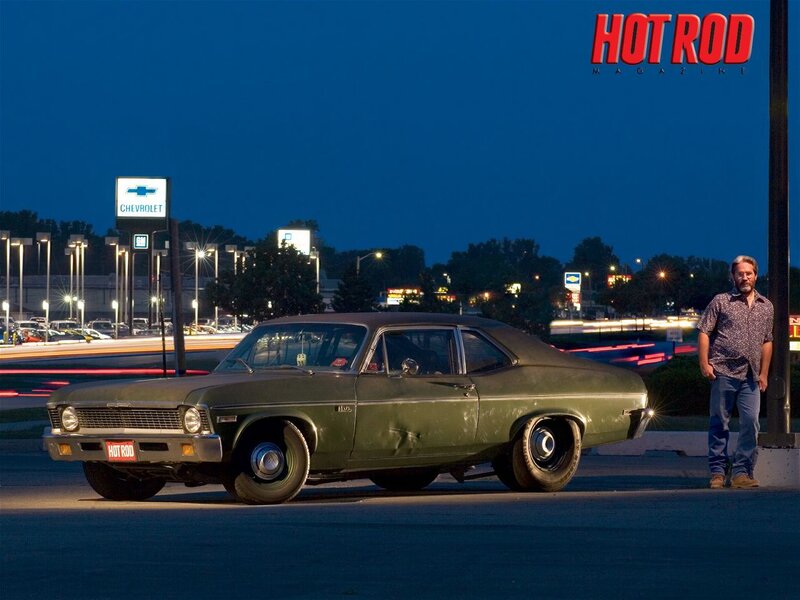 Man with classic car at night