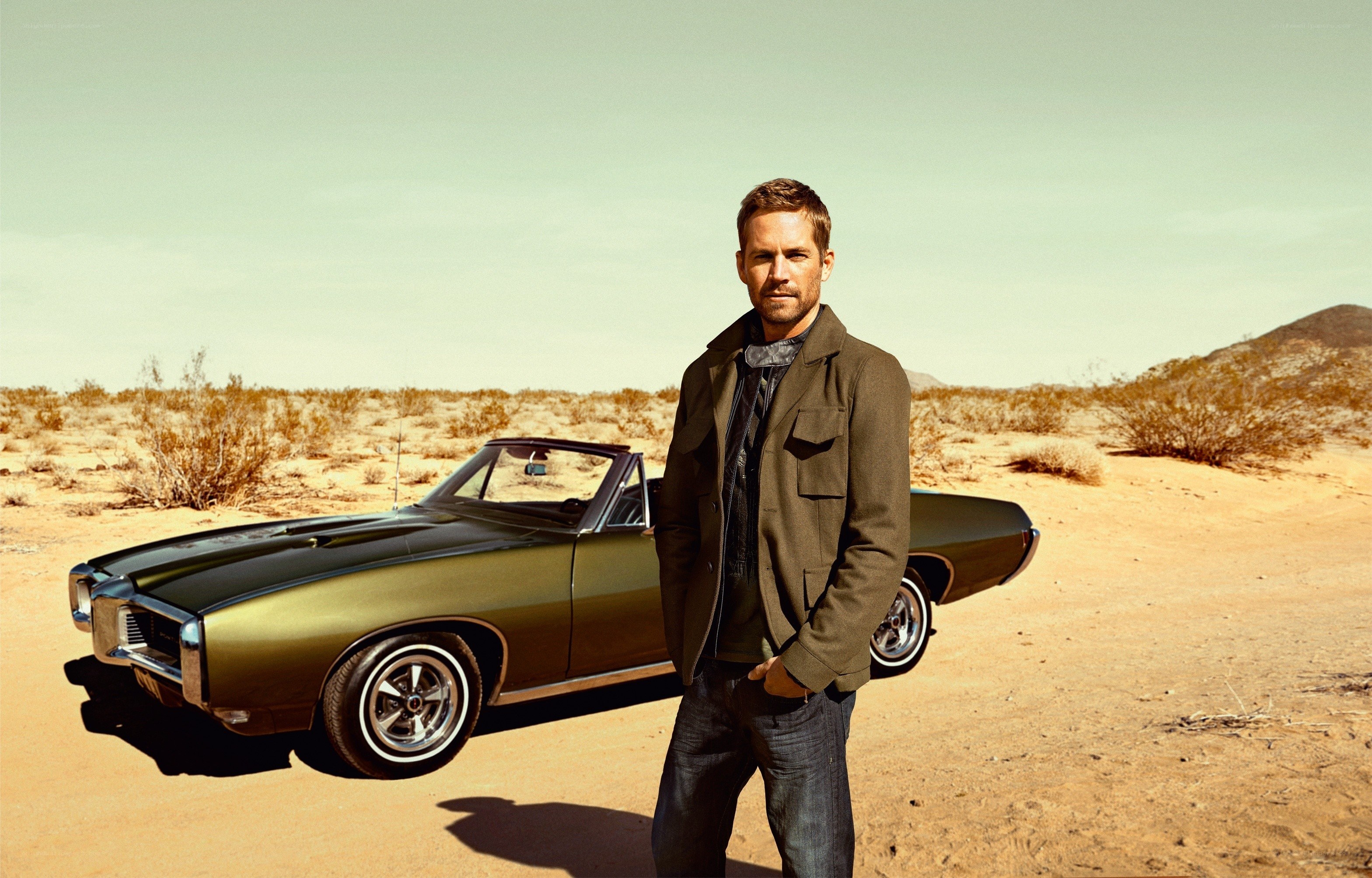 man with classic car in desert