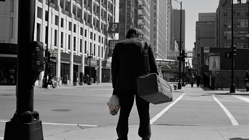 Man with clown mask in city