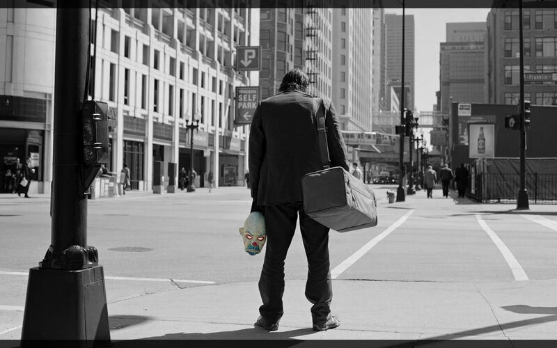 Man with clown mask on street