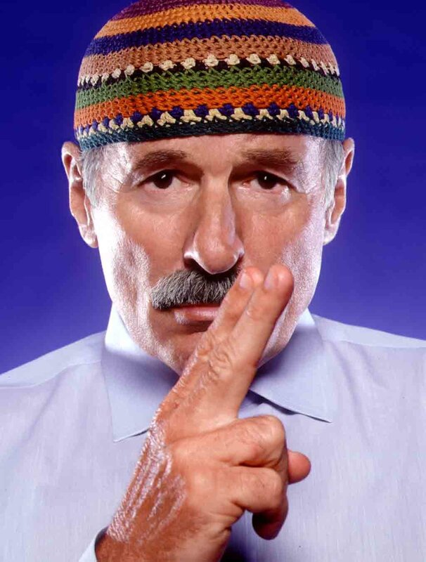 man with colorful hat and finger gesture