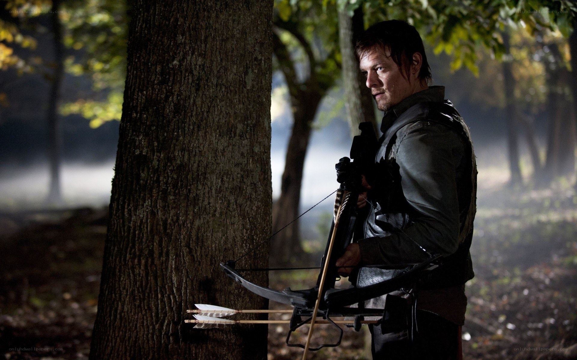 man with crossbow in forest