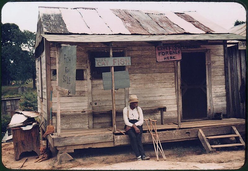 Man with crutches outside fish shop