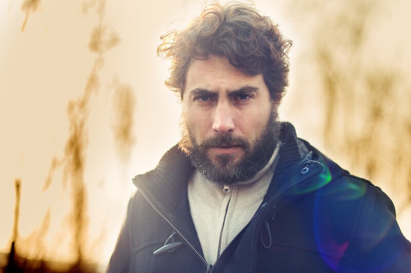 man with curly hair and beard