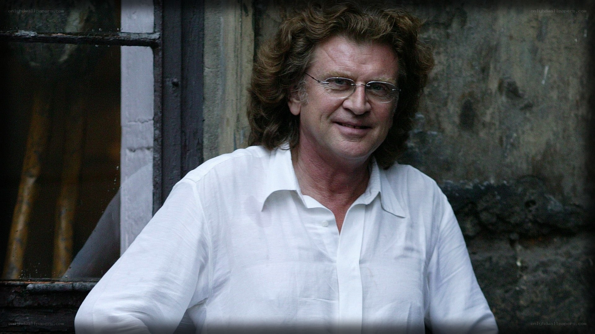 Man with curly hair and glasses