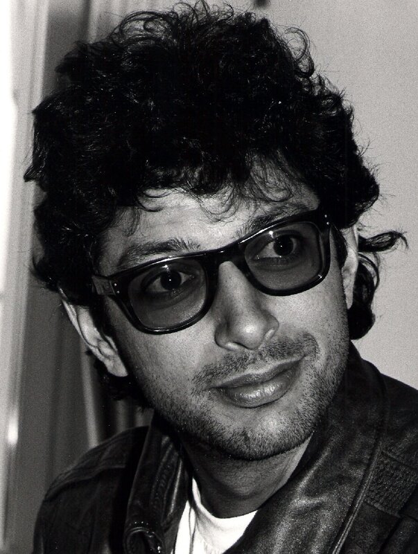 man with curly hair and glasses