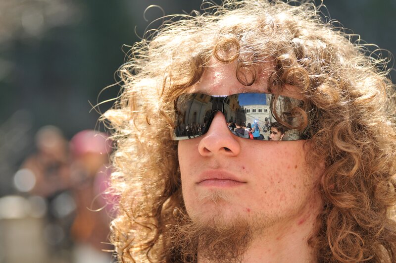 man with curly hair and sunglasses