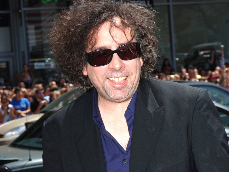 man with curly hair and sunglasses