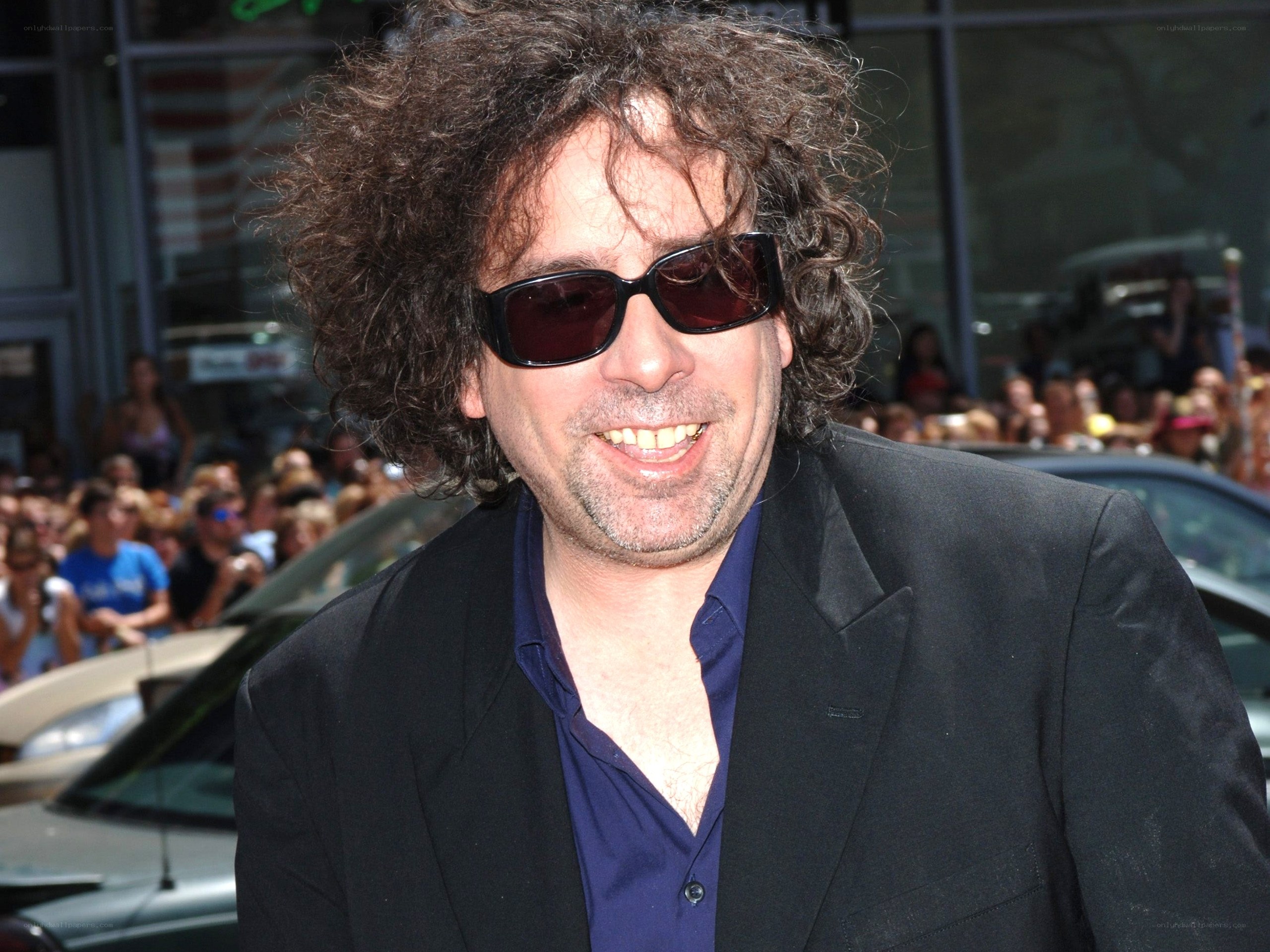 man with curly hair and sunglasses