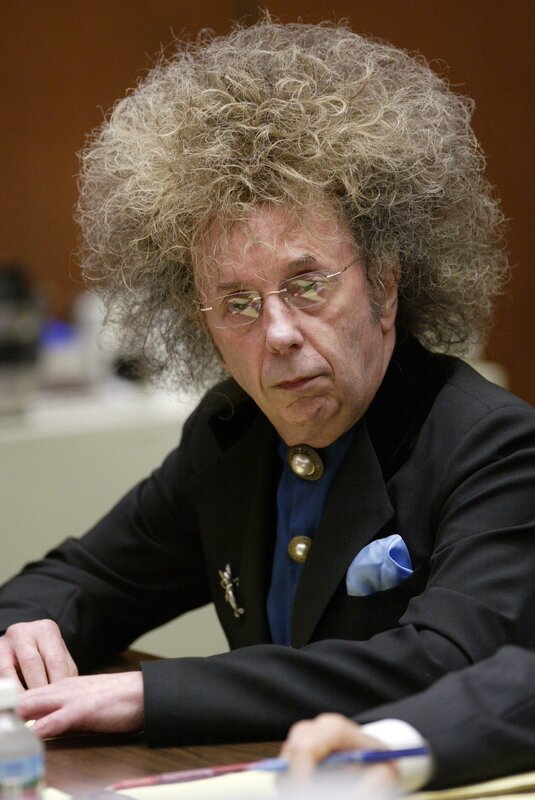 Man with curly hair at a table