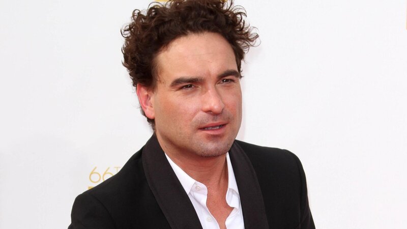 man with curly hair at event