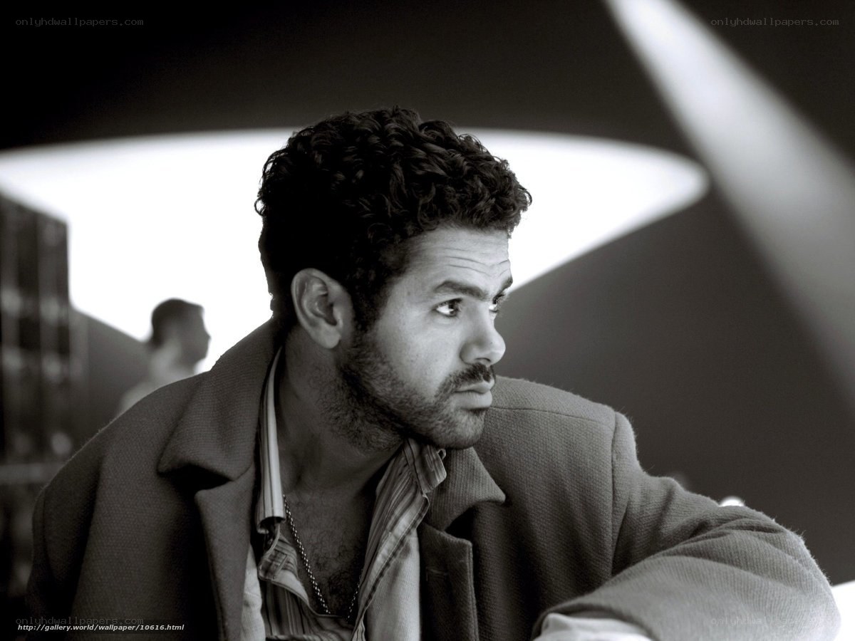 man with curly hair in black and white