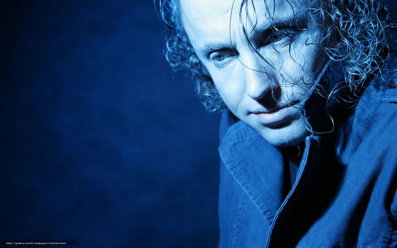 man with curly hair in blue light