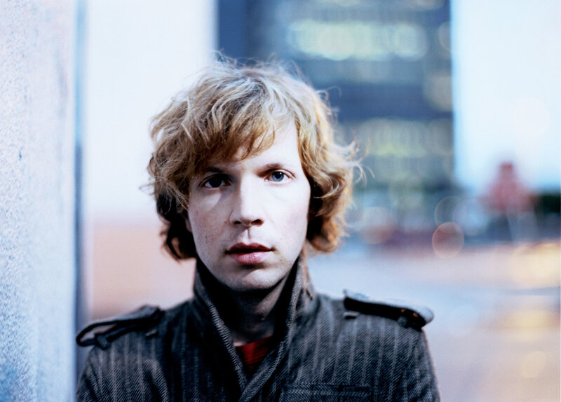 man with curly hair in city