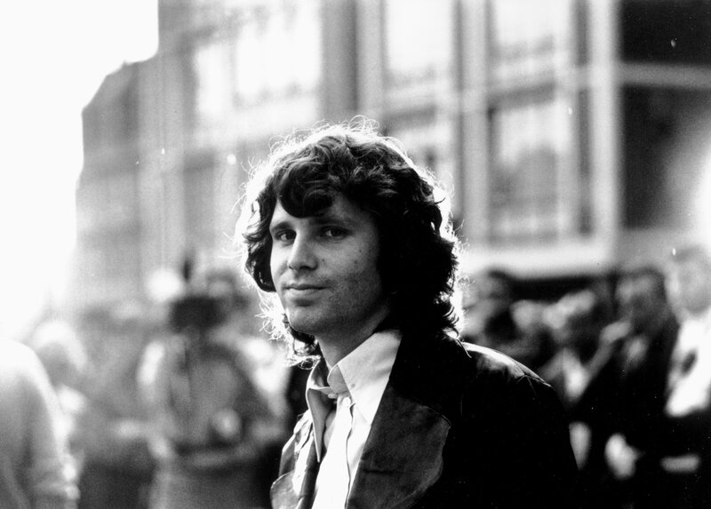 Man with curly hair in crowd