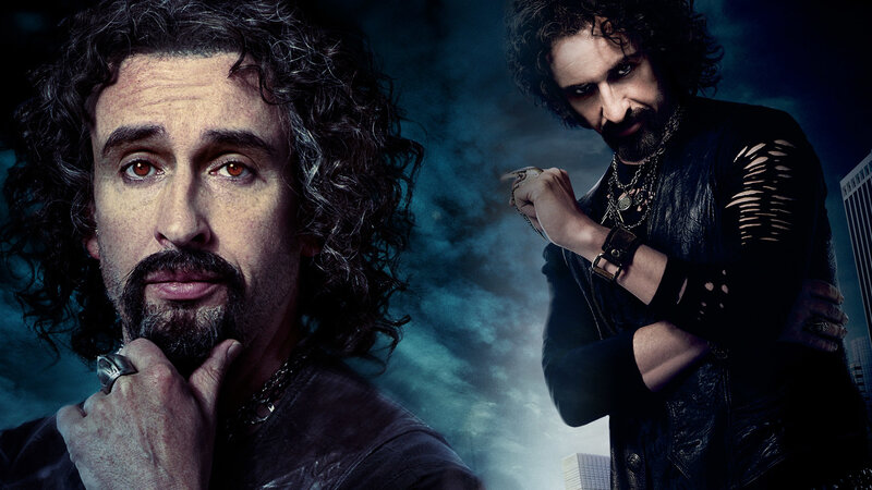 man with curly hair in dark setting