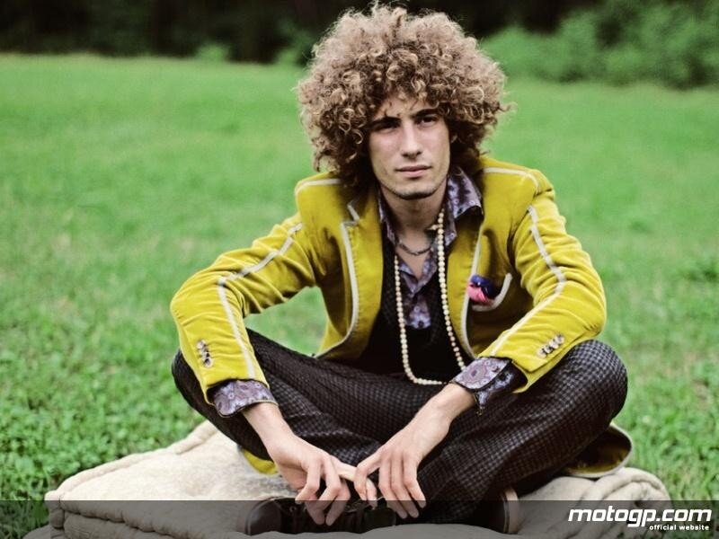 man with curly hair in field