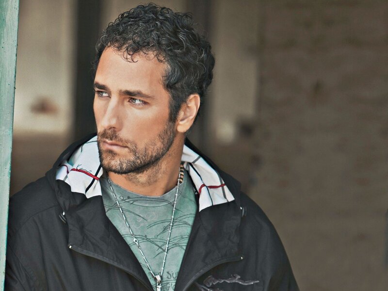 man with curly hair in jacket