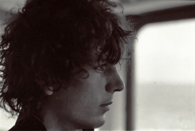 man with curly hair in profile