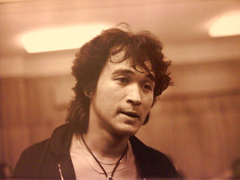 man with curly hair in sepia