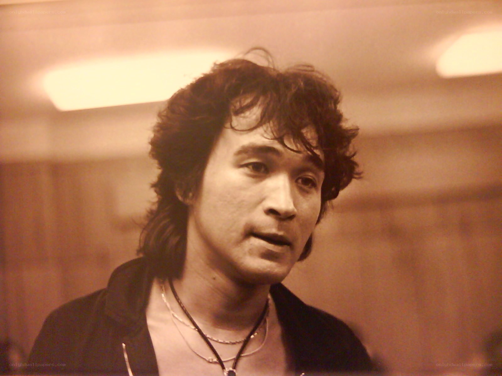 man with curly hair in sepia