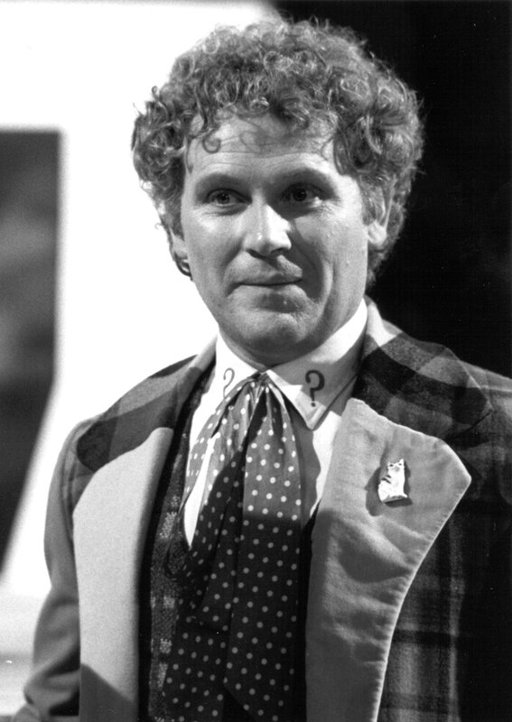 man with curly hair in suit