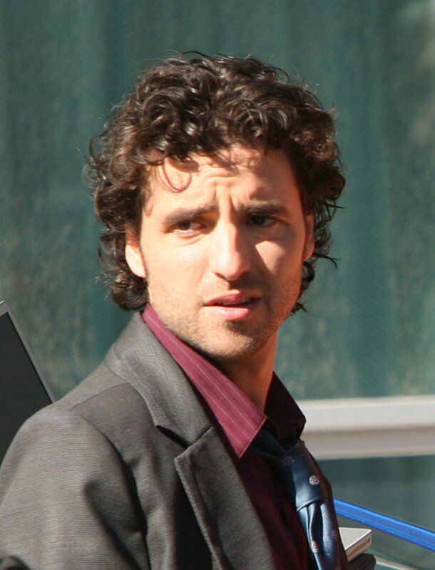 man with curly hair in suit