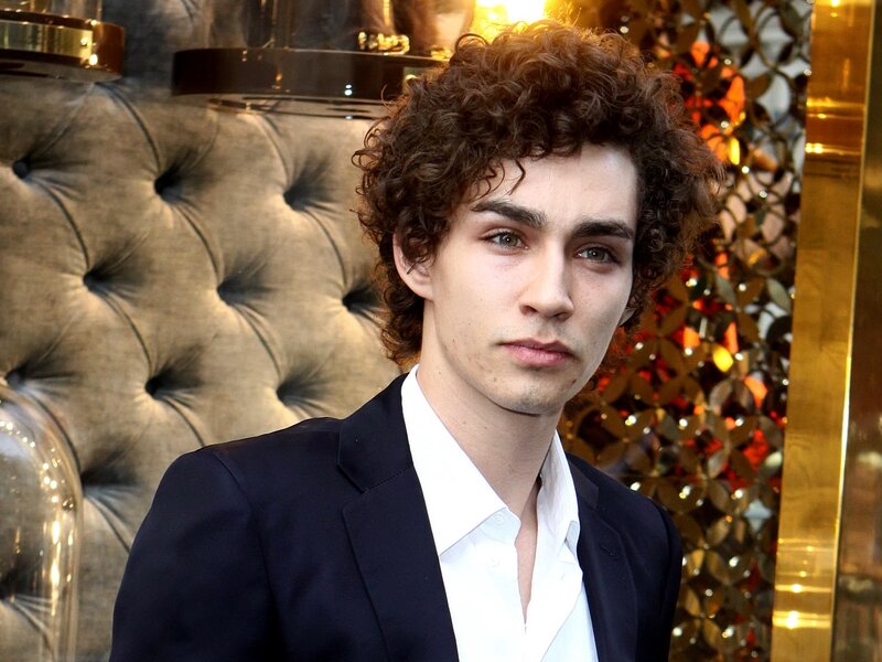 man with curly hair in suit