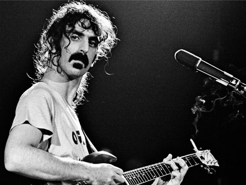 Man with Curly Hair Playing Guitar