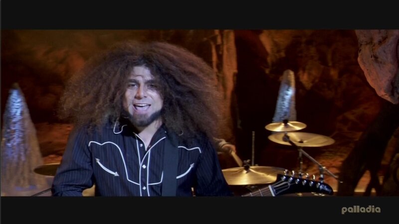 man with curly hair singing