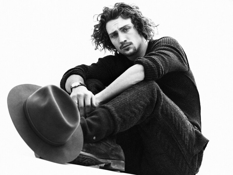 man with curly hair sitting