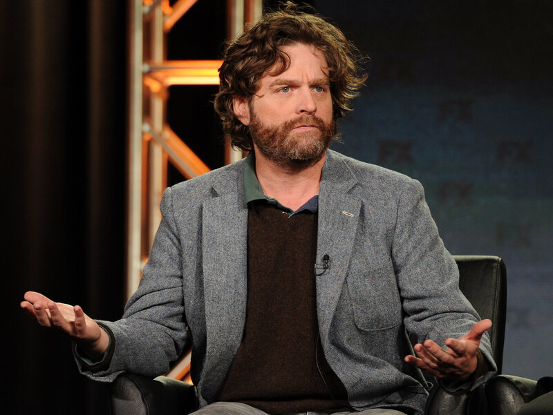 man with curly hair sitting