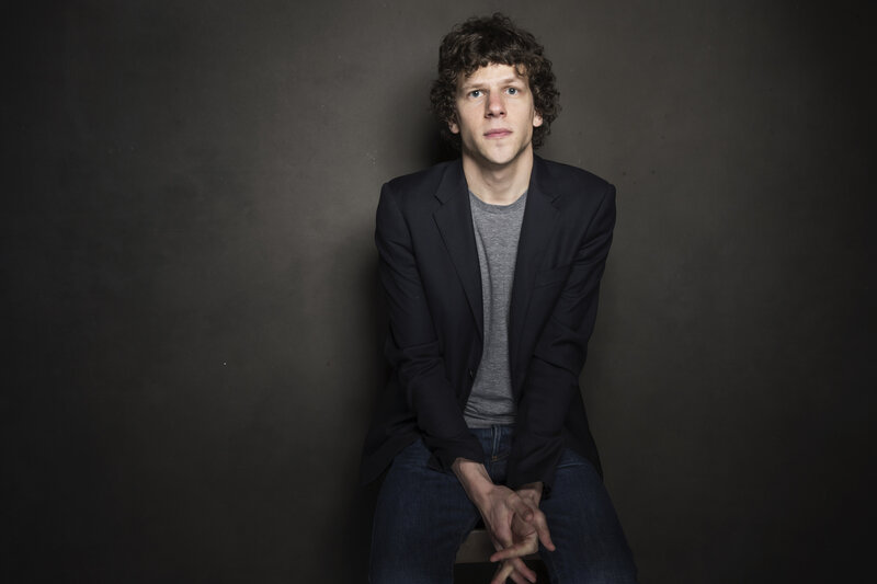 man with curly hair sitting
