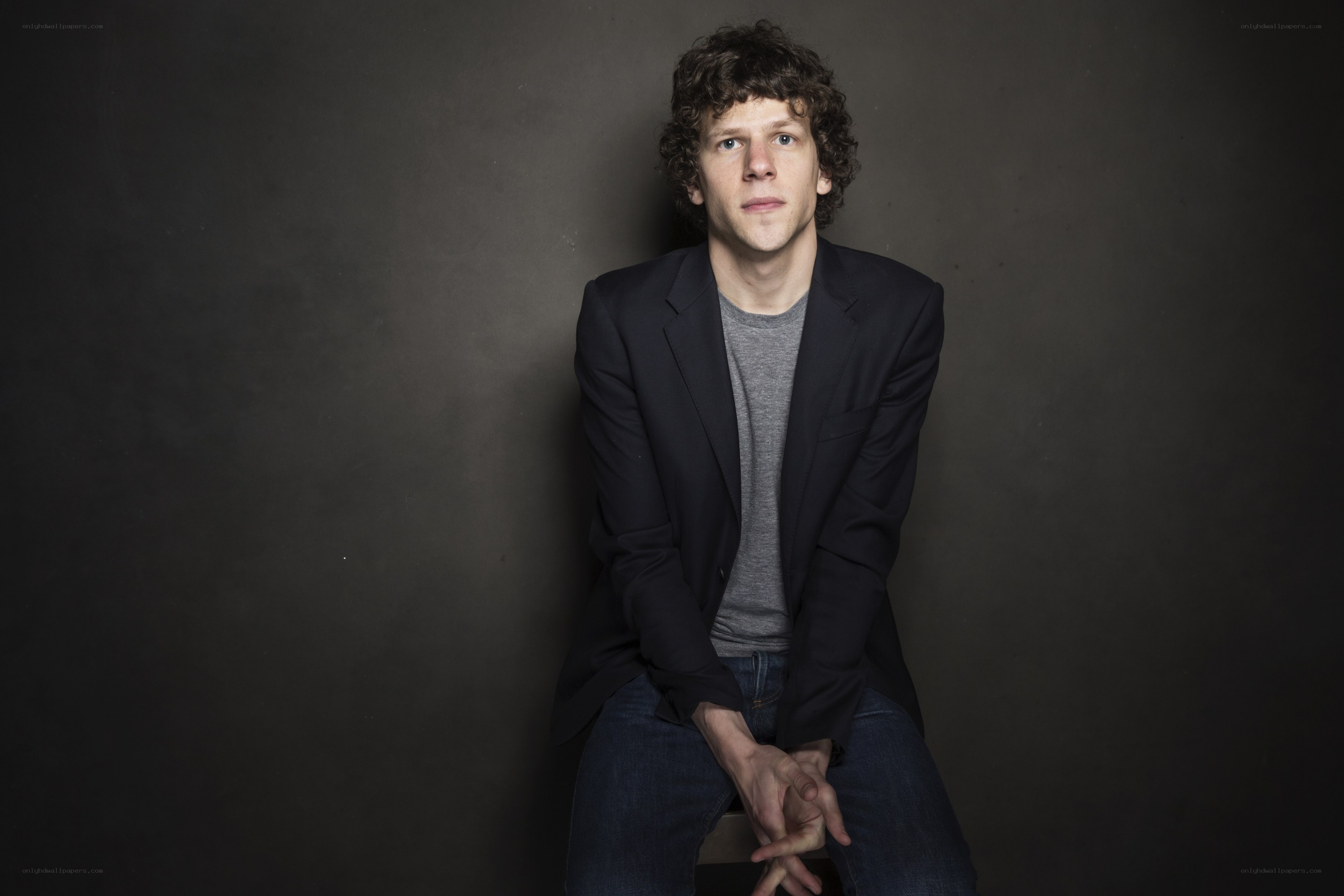 man with curly hair sitting