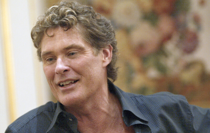 man with curly hair smiling
