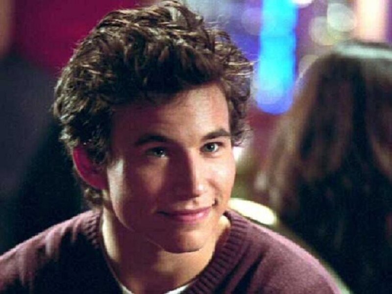 man with curly hair smiling
