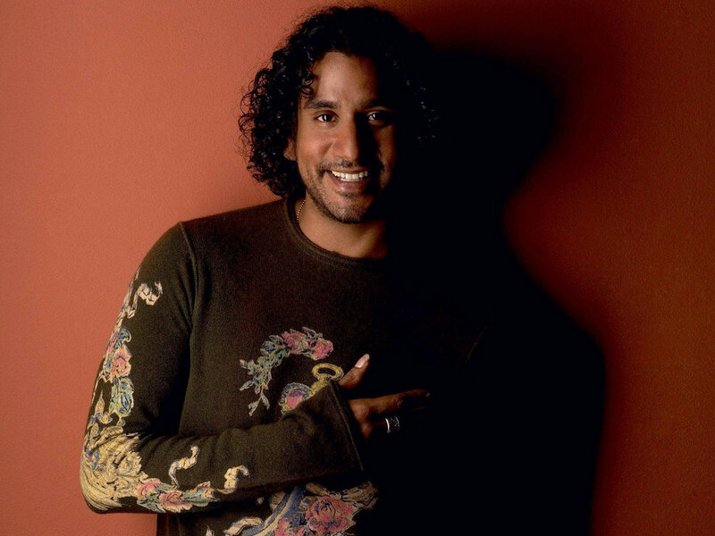 man with curly hair smiling