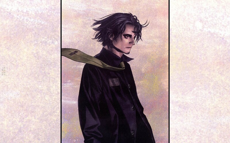 man with dark hair and coat