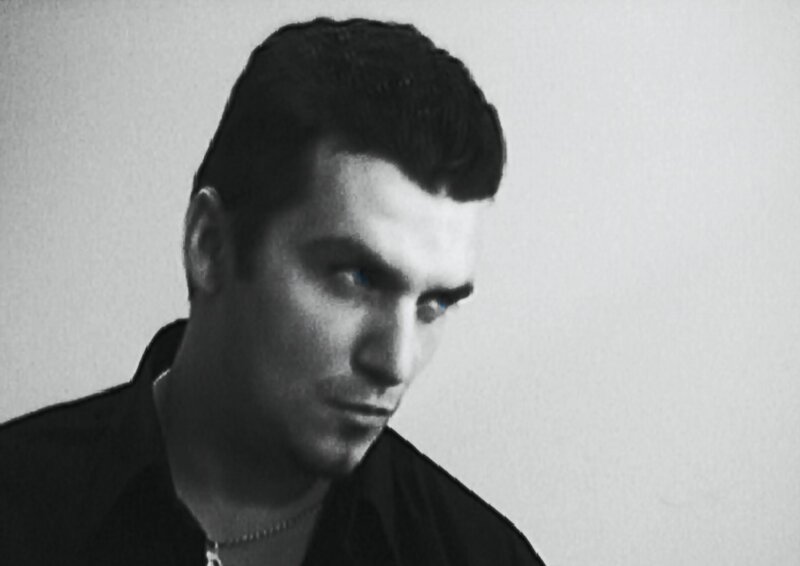 Man with Dark Hair — Black, Serious, Photograph, Necklace