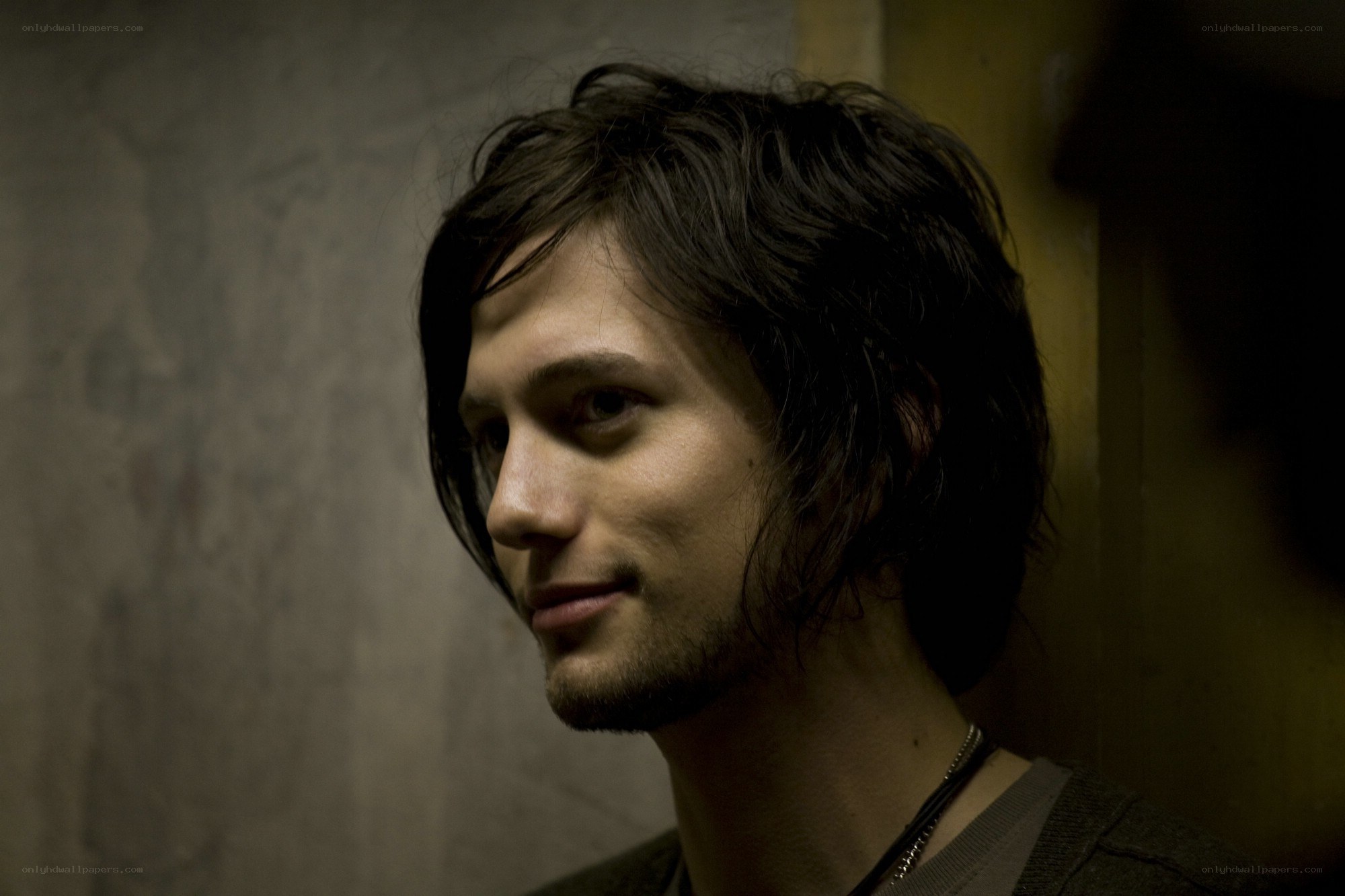 man with dark hair in dim light