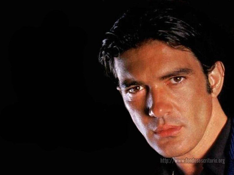 man with dark hair looking at camera