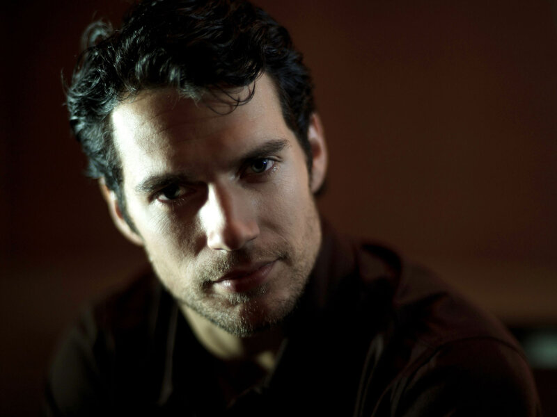 man with dark hair looking at camera