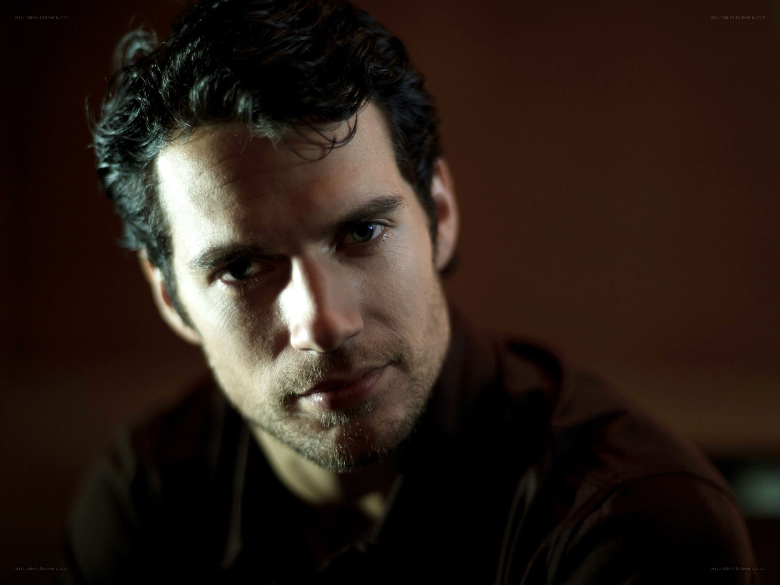 man with dark hair looking at camera