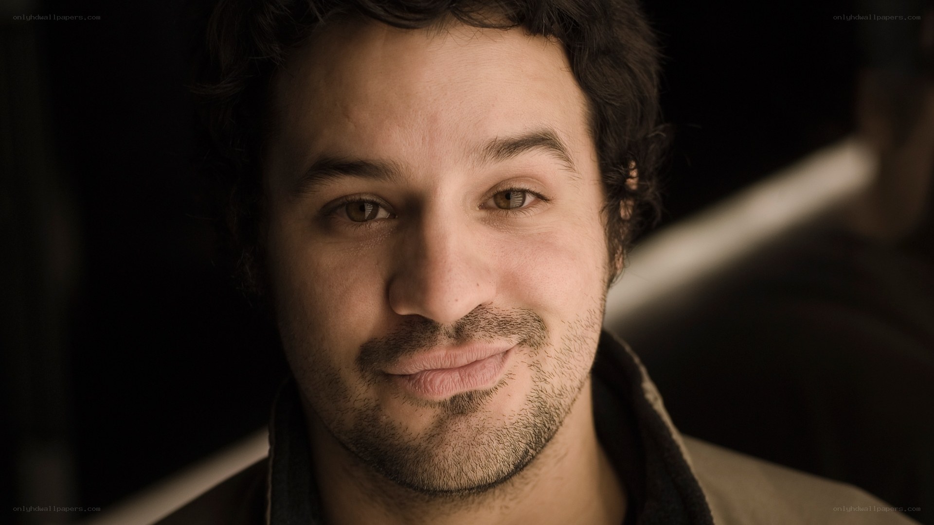 man with dark hair smiling