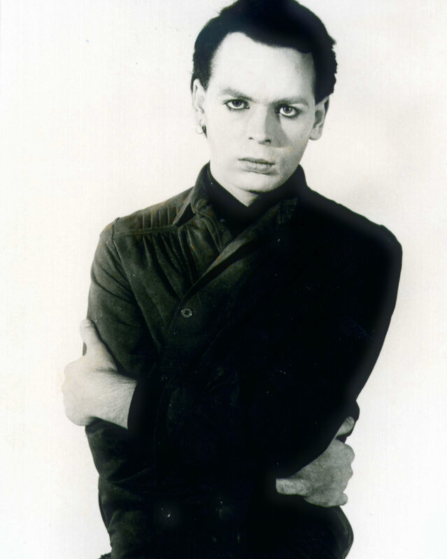 man with dark makeup and arms crossed
