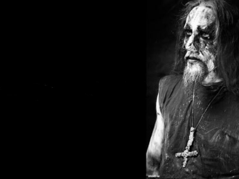 Man with dark makeup and cross