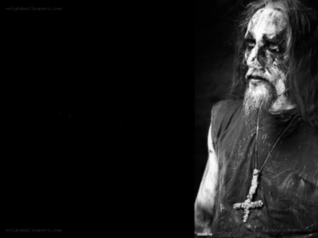 Man with dark makeup and cross