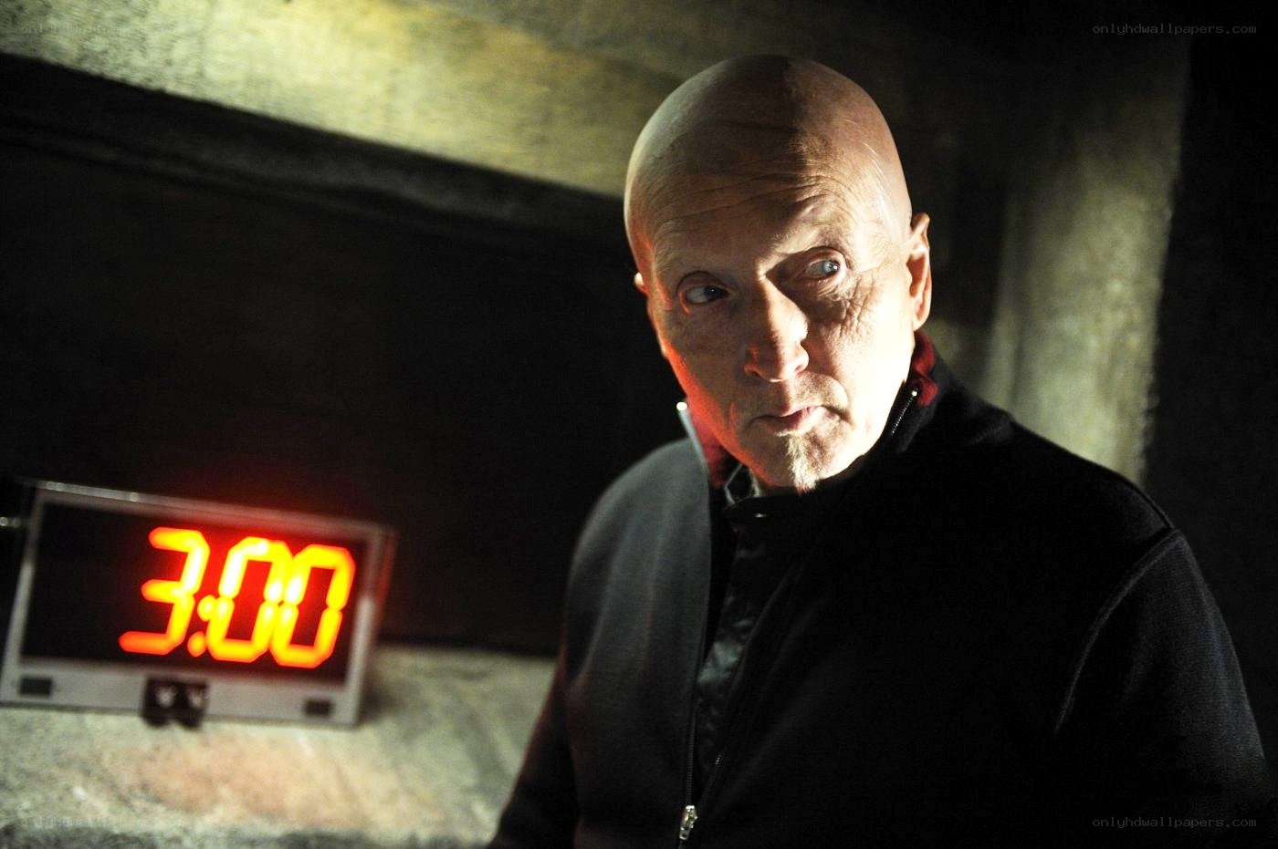 Man with digital clock showing 3:00