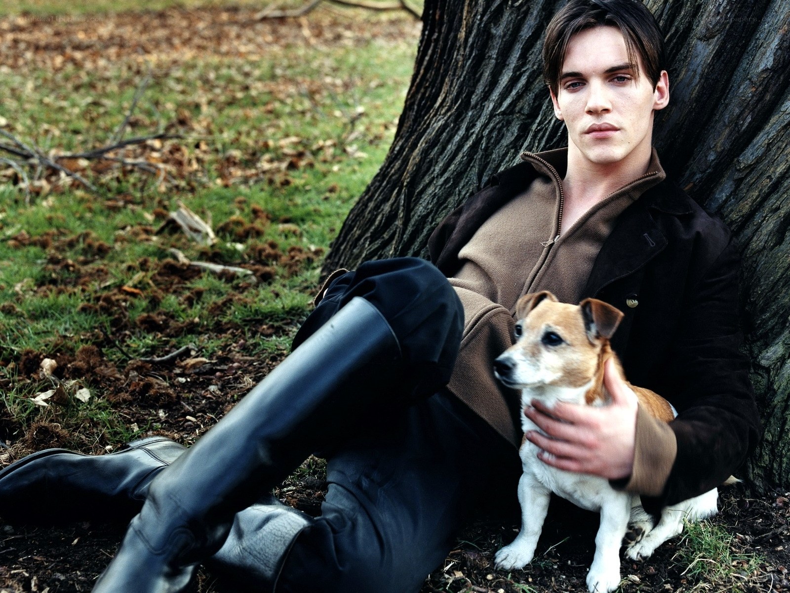 man with dog by tree